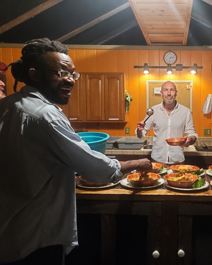 Terry plating bowls of food in a retreat kitchen