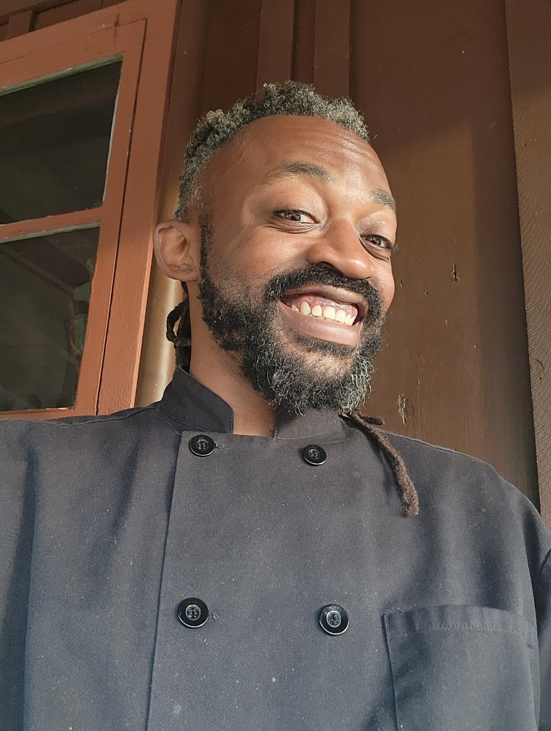 Terry Ford smiling in his chef’s jacket